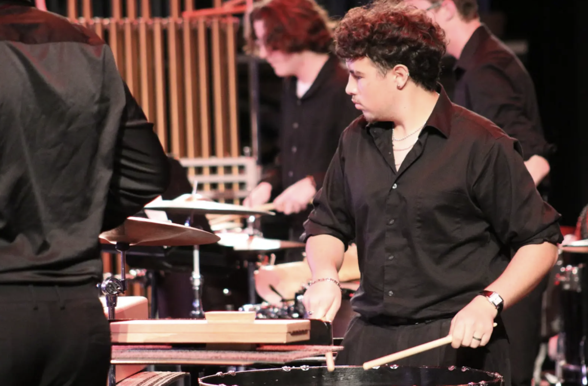 Senior Daniel Mohid plays the Bass Drum in Wind Ensemble's piece called "Sizzle" during the Fall Concert. Center Grove Percussion had their Fall Concert on Wednesday, November 13th where they perform music from each ensemble and host a collegiate band. This year University of Alabama played to close the concert.